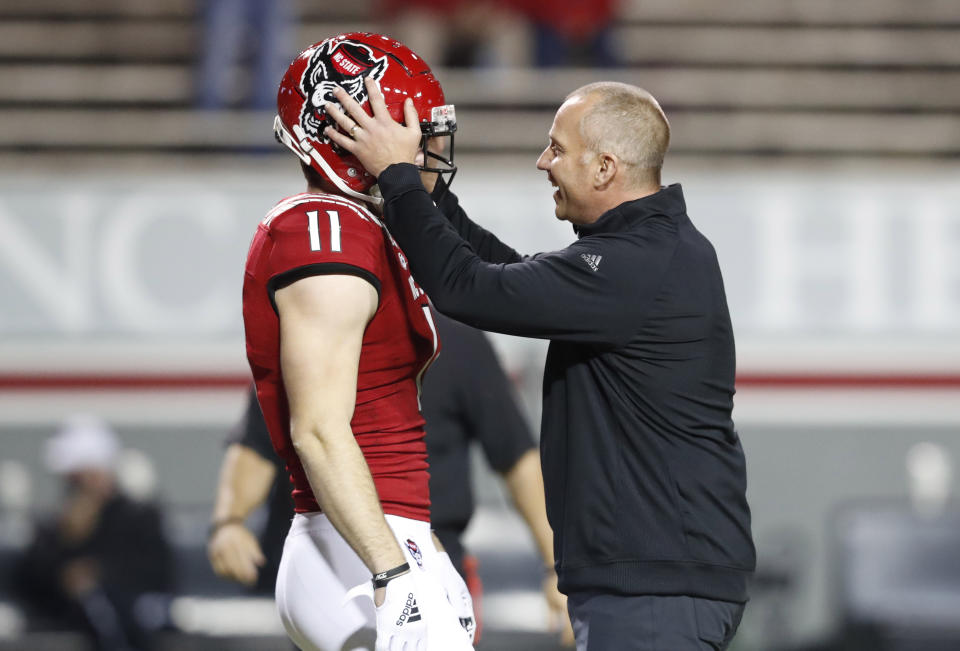 North Carolina State head coach Dave Doeren, right, talks with linebacker Payton Wilson (11) before an NCAA college football game against Liberty in Raleigh, N.C., Saturday, Nov. 21, 2020. (Ethan Hyman/The News & Observer via AP, Pool)