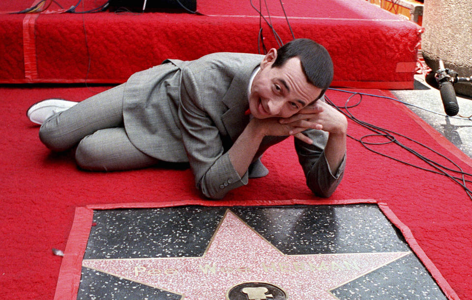 FILE - Comedian Pee Wee Herman, whose real name is Paul Reubens, admires his star on the Walk of Fame in Hollywood, Calif., in this July 20, 1988 file photo. Reubens died Sunday night after a six-year struggle with cancer that he did not make public, his publicist said in a statement. (AP Photo/Ira Mark Gostin, File)