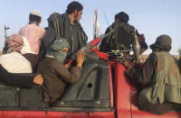 FILE- In this June 16, 2018 photo, Taliban fighters ride in their vehicle in Surkhroad district of Nangarhar province, east of Kabul, Afghanistan. Many Afghans view Saturday's expected signing of a U.S.-Taliban peace deal with a heavy dose of well-earned skepticism. They've spent decades living in a country at war -- some their whole lives — and wonder if they can ever reach a state of peace. (AP Photo/Rahmat Gul, file)