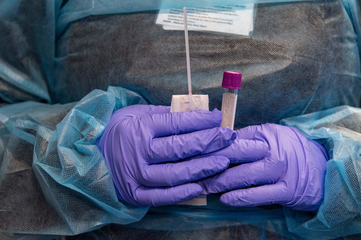 A medical worker prepares a COVID PCR test