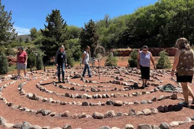 <p>Courtesy Selah Carefarm</p> Bereaved parents walking the Sento il Sol Labyrinth.