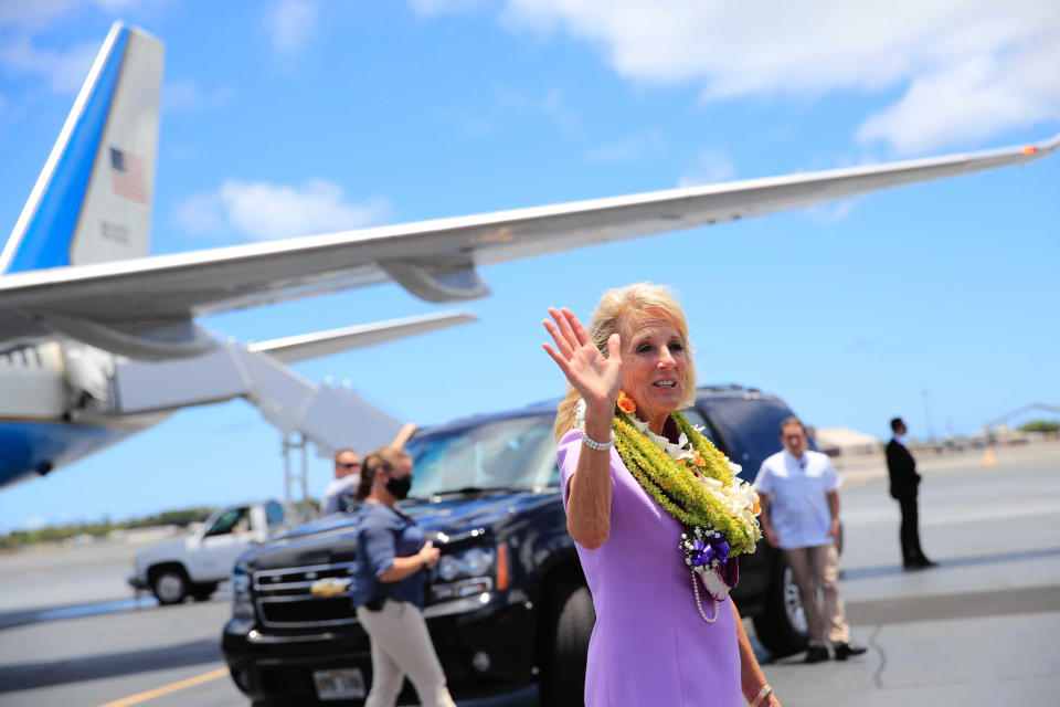 First lady Jill Biden waves to the media on the tarmac after arriving at Joint Base Pearl Harbor-Hickam, Hawaii, Saturday, July 24, 2021. (Jamm Aquino/Honolulu Star-Advertiser via AP)