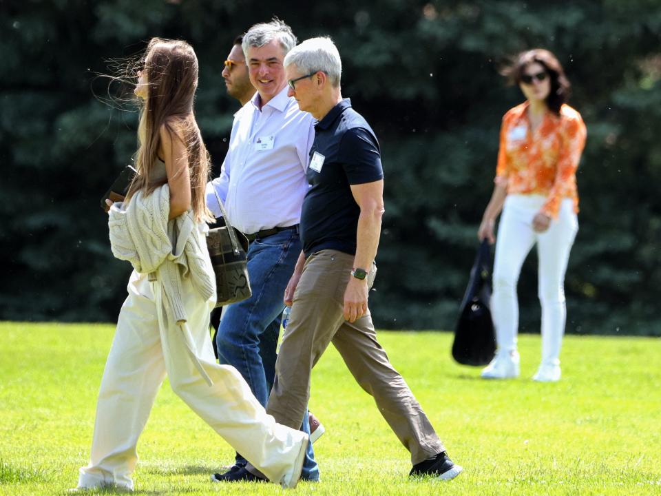 Eddy Cue walking with Tim Cook outside at Sun Valley