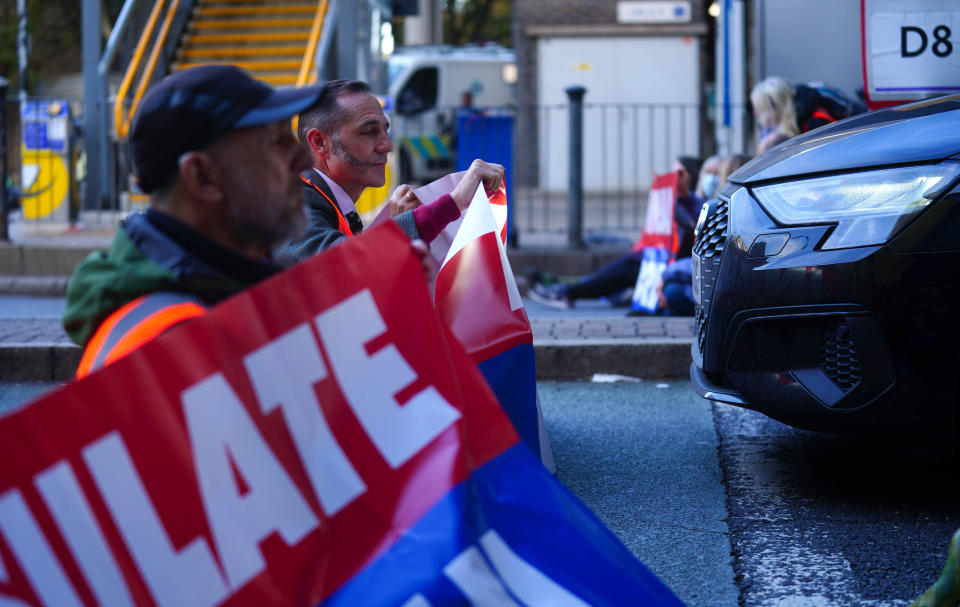 Protesters from Insulate Britain blocking a road near Canary Wharf in east London. Climate group Insulate Britain had pledged to restart its road-blocking protests despite the risk of its members being jailed or fined. Picture date: Monday October 25, 2021.