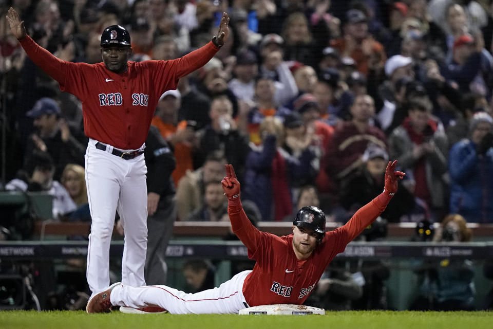 Boston Red Sox's Christian Arroyo celebrates a triple against the Houston Astros during the fourth inning in Game 4 of baseball's American League Championship Series Tuesday, Oct. 19, 2021, in Boston. (AP Photo/David J. Phillip)