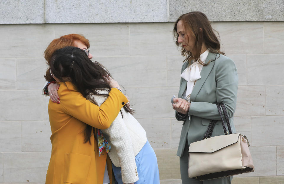 Rita Bonner, left, sister of John Laverty who was shot, with relatives arrive for the inquest into the Ballymurphy shooting, in Belfast, Northern Ireland, Tuesday May 11, 2021. The findings of the inquest into the deaths of 10 people during an army operation in August 1971 is due to be published on Tuesday. (AP Photo/Peter Morrison)