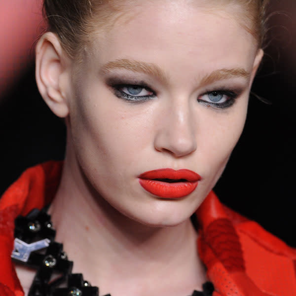 <b>Holly Fulton </b><br><br>Models' lips were outlined with dark lip liner and filled in with pillarblock red lipstick.<br><br>© Getty