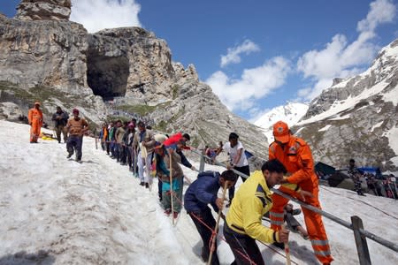 Hindu pilgrims leave the holy cave of Lord Shiva after worshipping in Amarnath