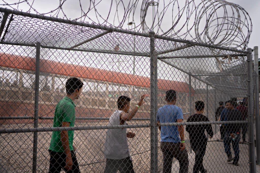 Migrants are led into Mexico after being deported by U.S. authorities in El Paso, Texas. The Washington Post via Getty Images