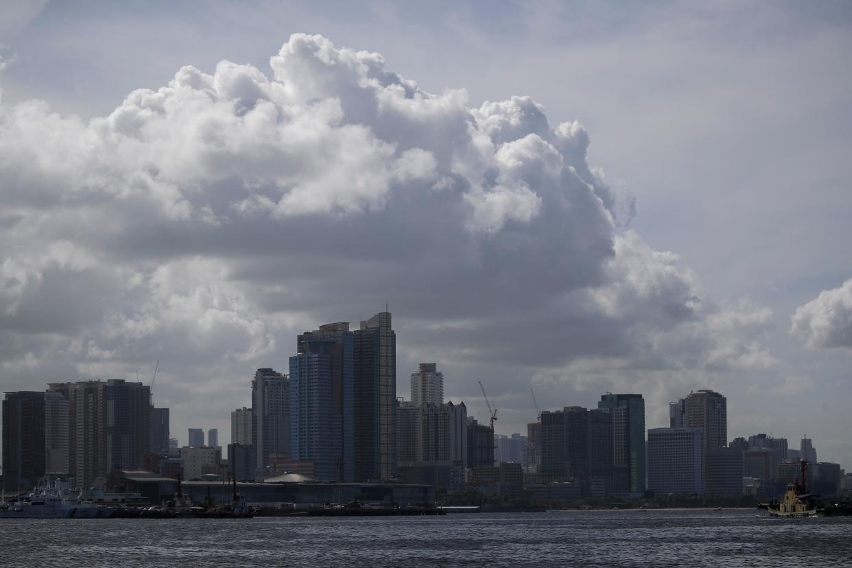 Clouds gather over the skyline in Manila amid rain warnings in the Philippines (EPA)