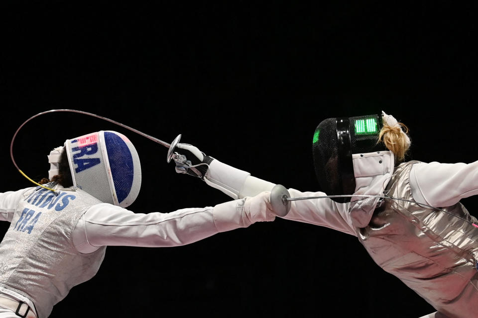 <p>France's Ysaora Thibus (L) compete against Hungary's Flora Pasztor in the women's foil individual qualifying bout during the Tokyo 2020 Olympic Games at the Makuhari Messe Hall in Chiba City, Chiba Prefecture, Japan, on July 25, 2021. (Photo by MOHD RASFAN / AFP) (Photo by MOHD RASFAN/AFP via Getty Images)</p> 