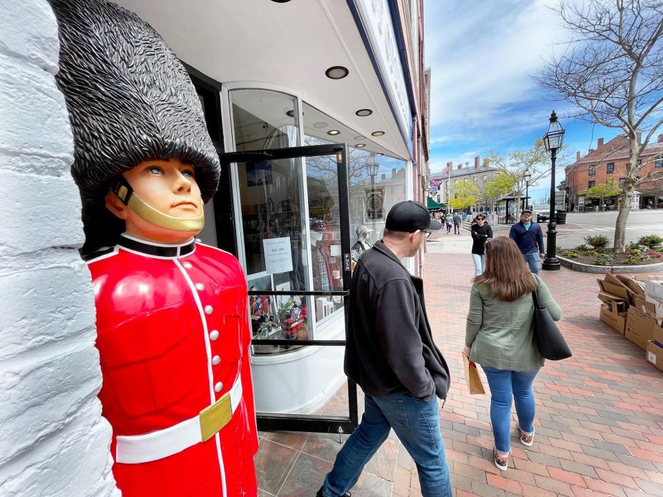 Pedestrians exit the Best of British shop and head toward the center of Market Square in Portsmouth Monday, April 29, 2024.