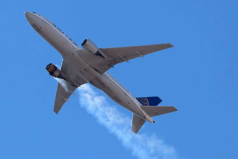 FILE PHOTO: United Airlines flight UA328 returns to Denver International Airport with its starboard engine on fire after it called a Mayday alert