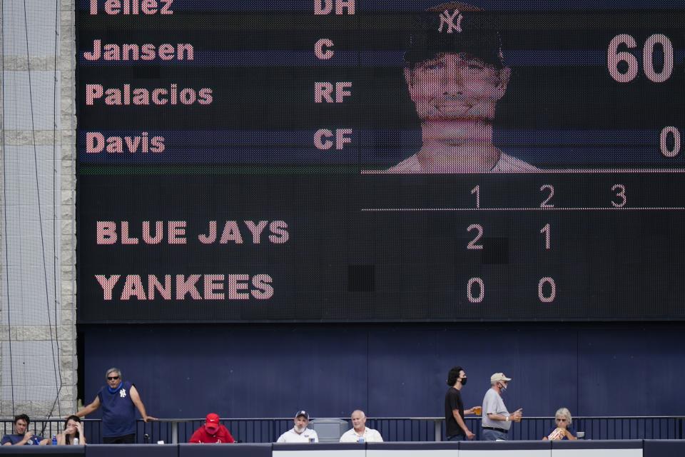 Fans watch the Toronto Blue Jays play the New York Yankees before the third inning of a spring baseball game Sunday, Feb. 28, 2021, in Tampa, Fla. (AP Photo/Frank Franklin II)