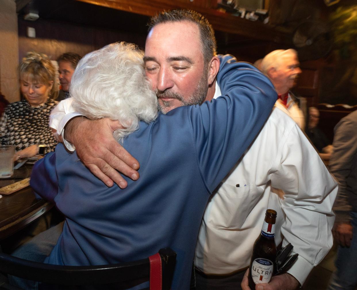 William V. Sherer II is congratulated by longtime family friend Nikki Ardelea at the Conestoga Grill in downtown Canton Tuesday. Sherer has been elected Canton's new mayor, unofficial election results show.