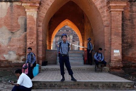 Myanmar policemen stand outside a collapsed pagoda after an earthquake in Bagan, Myanmar August 25, 2016. REUTERS/Soe Zeya Tun