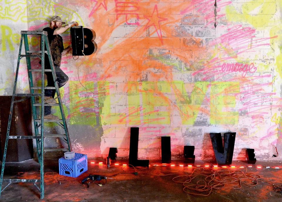 Recycling artist Dana Maltby of Minneapolis, Minnesota works on a piece at the former Pillsbury Mills plant Wednesday, Nov. 8, 2023 as part of an art exhibit for Moving Pillsbury Forward.
