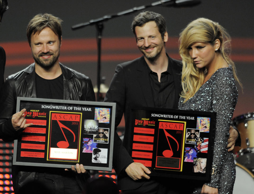 FILE - In this April 27, 2011 file photo, songwriters Max Martin, from left, and Lukasz "Dr. Luke" Gottwalk, pose with singer Kesha after receiving their awards at the 28th Annual ASCAP Pop Music Awards in Los Angeles. Gottwalk, the controversial music producer and hitmaker rose to the top of the Billboard charts with Doja Cat’s ubiquitous funk-pop jam “Say So,” along with Saweetie's anthemic bop “Tap In” and Juice WRLD's Top 5 pop smash “Wishing Well." He appeared as Tyson Trax on the Grammy ballot for Doja Cat's “Say So," which he produced and co-wrote. The hit tune is competing for record of the year, where he is contention as the song’s producer. (AP Photo/Chris Pizzello, file)