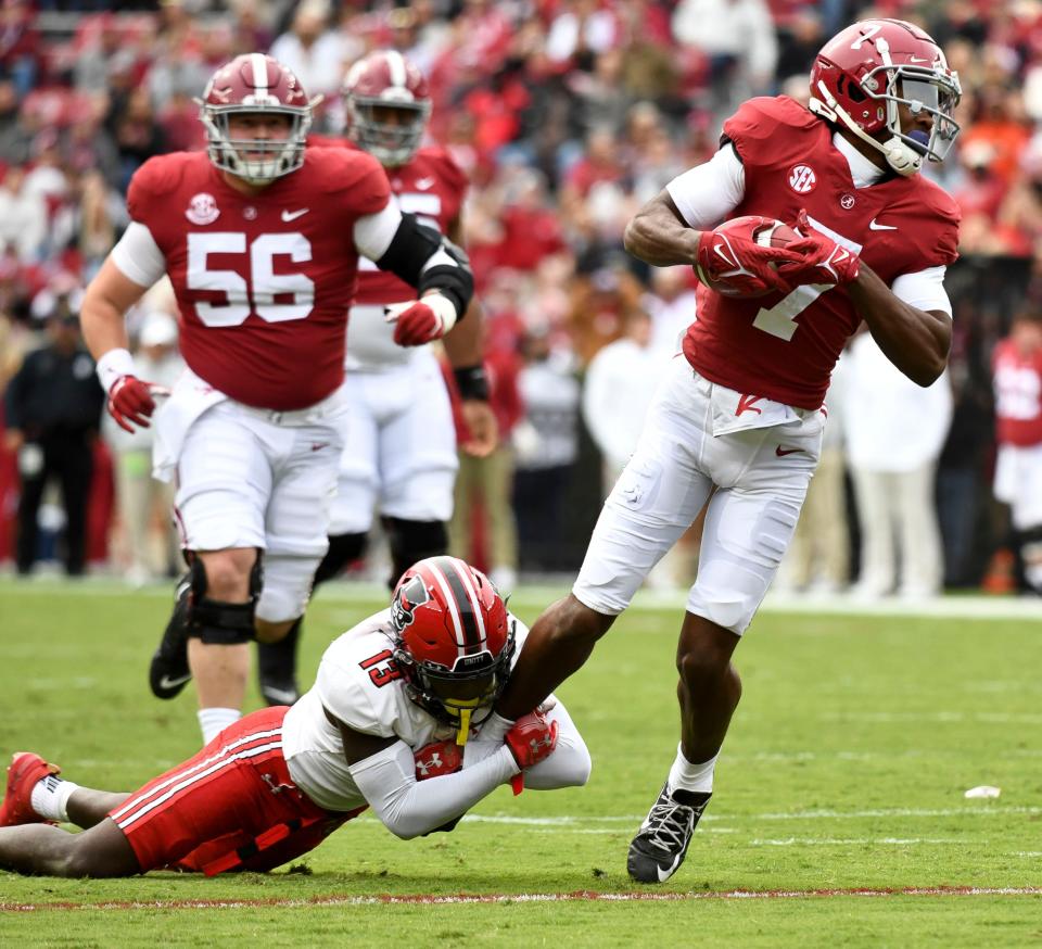 Nov 19, 2022; Tuscaloosa, Alabama, USA;  Austin Peay defensive back Cedarius Doss (13) hangs on as Alabama wide receiver Ja'Corey Brooks (7) tries to break away after catching a pass at Bryant-Denny Stadium. Mandatory Credit: Gary Cosby Jr.-USA TODAY Sports