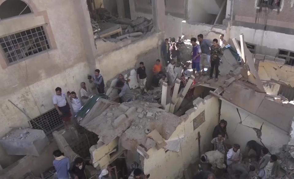 In this frame grab from from video, people search in the rubble following Saudi-led coalition airstrikes that killed at least six, including children, officials said, in the residential center of the capital, Sanaa, Yemen, Thursday, May 16, 2019. The Sanaa airstrikes came after Yemen's Iran-backed Houthi rebels, who control the capital, launched a drone attack earlier in the week on a critical oil pipeline in Saudi Arabia, Tehran's biggest rival in the region. (AP Photo)