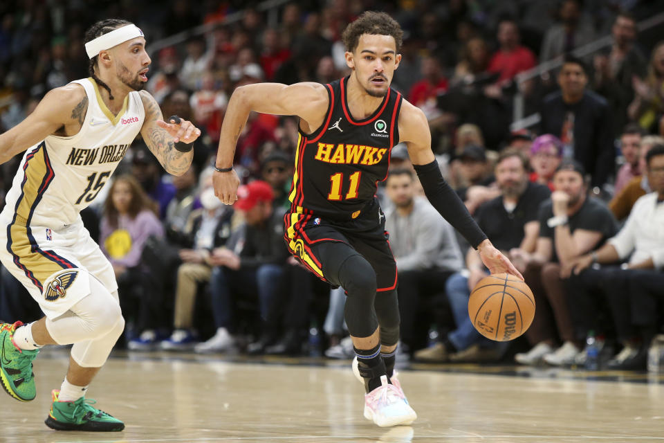 Atlanta Hawks guard Trae Young (11) drives past New Orleans Pelicans guard Jose Alvarado (15) in the second half of an NBA basketball game Sunday, March 20, 2022, in Atlanta, Ga. (AP Photo/Brett Davis)