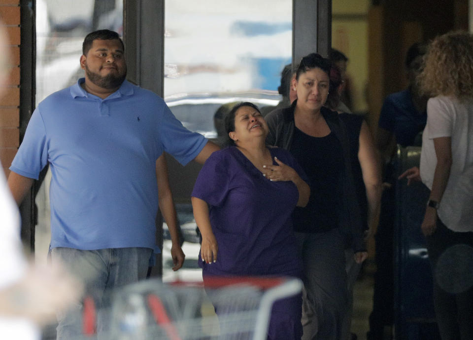 <p>People react as they leave the family unification center at the Alamo Gym, following a shooting at Santa Fe High School Friday, May 18, 2018, in Santa Fe, Texas. (Photo: David J. Phillip/AP) </p>