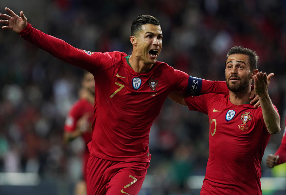 Cristiano Ronaldo of Portugal and Juventus celebrates with teammate Bernardo Silva.  (Photo by Gualter Fatia/Getty Images)