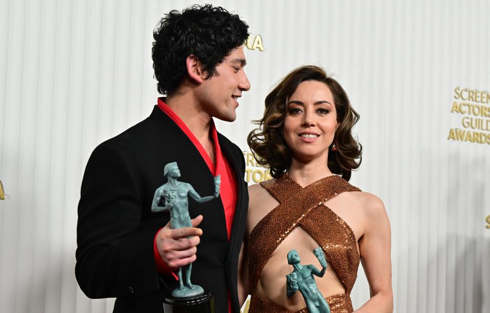 Actors Aubrey Plaza and Will Sharpe pose with the award for Outstanding Performance by an Ensemble in a Drama Series with the cast of "The White Lotus" during the 29th Screen Actors Guild Awards at the Fairmont Century Plaza in Century City, Calif., on Feb. 26, 2023.