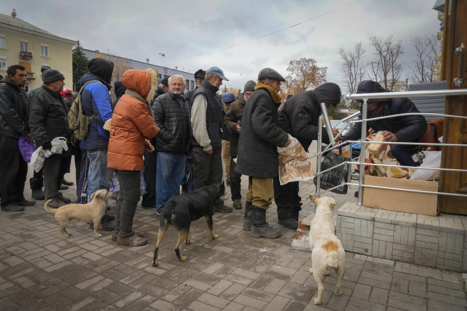 Local residents stand in line waiting for free bread from volunteers in Bakhmut, the site of the heaviest battle against the Russian troops in the Donetsk region, Ukraine, Friday, Oct. 28, 2022. (AP Photo/Efrem Lukatsky)