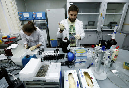 Technicians Ilya Podolsky and Natalia Bochkaryova work at the Russian anti-doping laboratory in Moscow, Russia, May 24, 2016. REUTERS/Sergei Karpukhin