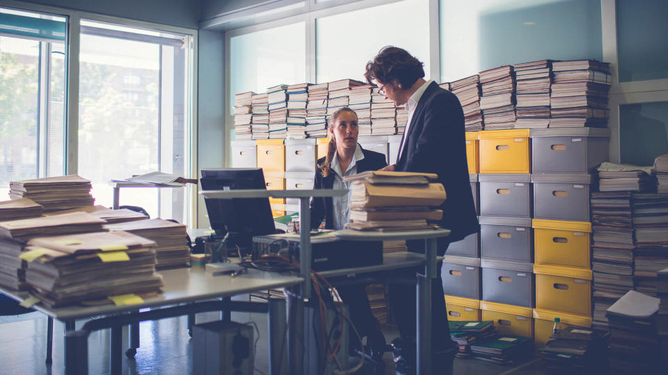 Overworked office workers, bureaucracy, archives.