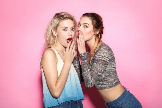 Two young girl gossiping (iStock)