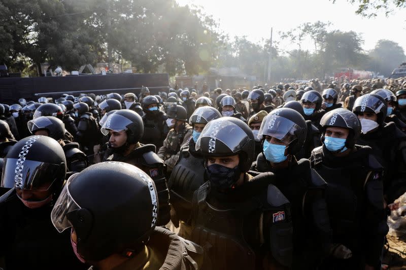 Police officers gather to stop farmers opposing the newly passed farm bills from entering the national capital Delhi, at Singhu border, India