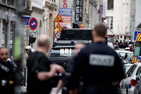 French police and special police forces (BRI) secure the street as a man has taken two people hostage at a business in Paris, France, June 12, 2018. REUTERS/Benoit Tessier