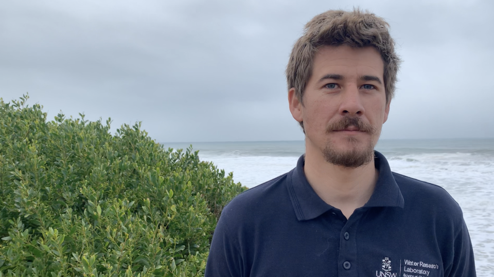 Pictured is Chris Drummond, from UNSW's Water Research Laboratory, in front of the ocean.