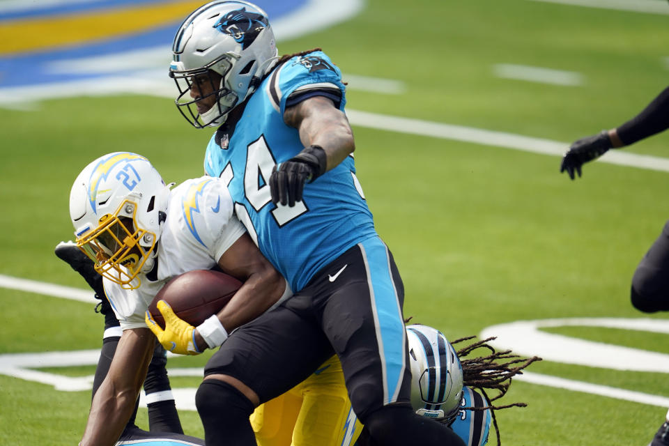 Carolina Panthers outside linebacker Shaq Thompson (54) forces a fumble from Los Angeles Chargers running back Joshua Kelley (27) during the first half of an NFL football game Sunday, Sept. 27, 2020, in Inglewood, Calif. (AP Photo/Alex Gallardo)