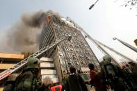 Iranian firefighters battle a blaze that engulfed the 15-storey Plasco building in Tehran, on January 19, 2017