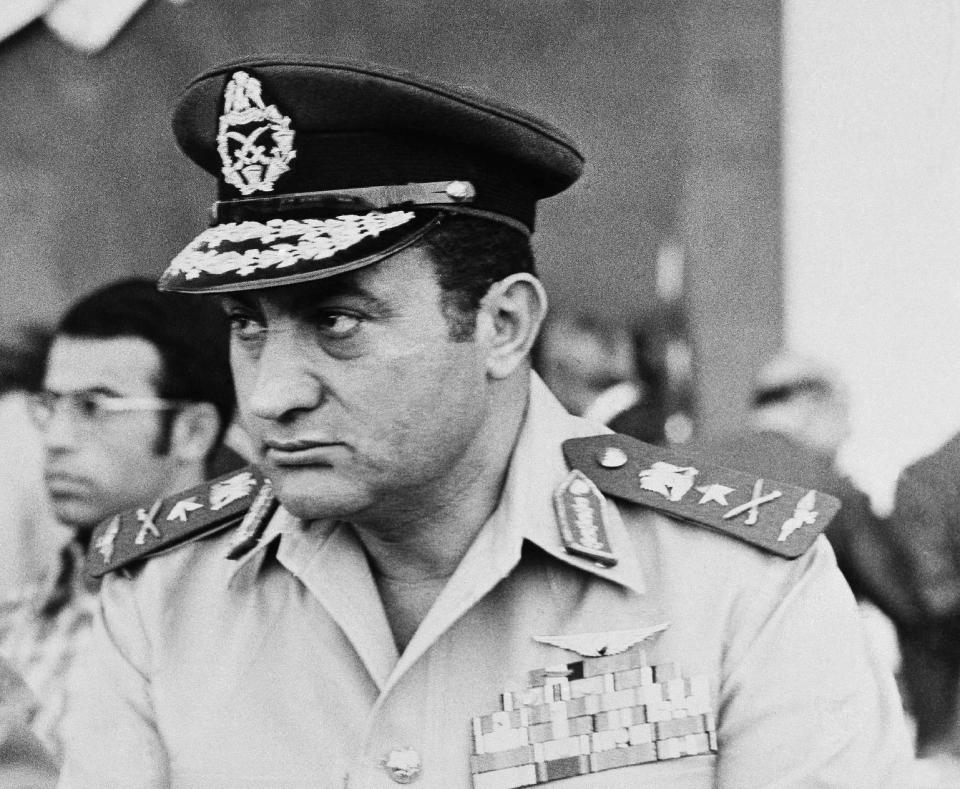 FILE - In this Sunday, Oct. 6, 1974 file photo taken by Harry Koundakjian, Egypt's Air Force commander Hosni Mubarak reviews a military parade in Cairo. Koundakjian a retired Associated Press photographer and photo editor died Monday, April 21, 2014, in New York. He was 83. (AP Photo/Harry Koundjakjian, File)