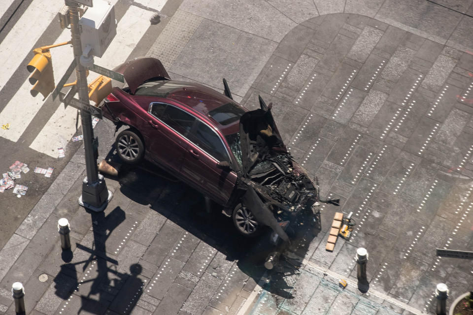 <p>A wrecked car sits in the intersection of 45th and Broadway in Times Square, May 18, 2017 in New York City. According to reports there were multiple injuries and one fatality after the car plowed into a crowd of people. (Photo: Drew Angerer/Getty Images) </p>