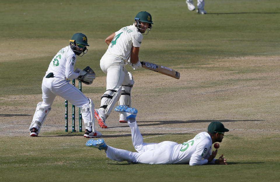 South Africa's Aiden Markram, center, looks to Pakistan's Babar Azam, bottom, who dropped his catch during the third day of the first cricket test match between Pakistan and South Africa at the National Stadium, in Karachi, Pakistan, Thursday, Jan. 28, 2021. (AP Photo/Anjum Naveed)