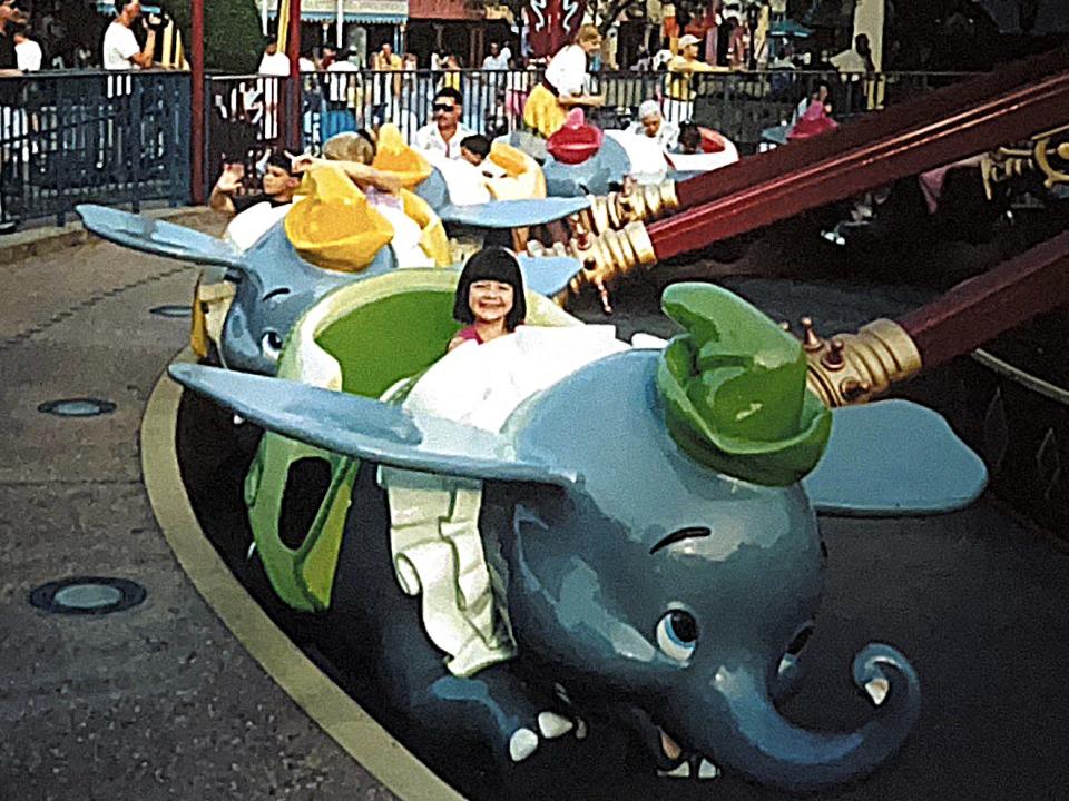 megan riding dumbo the flying elephant at disney world as a child 30 years ago