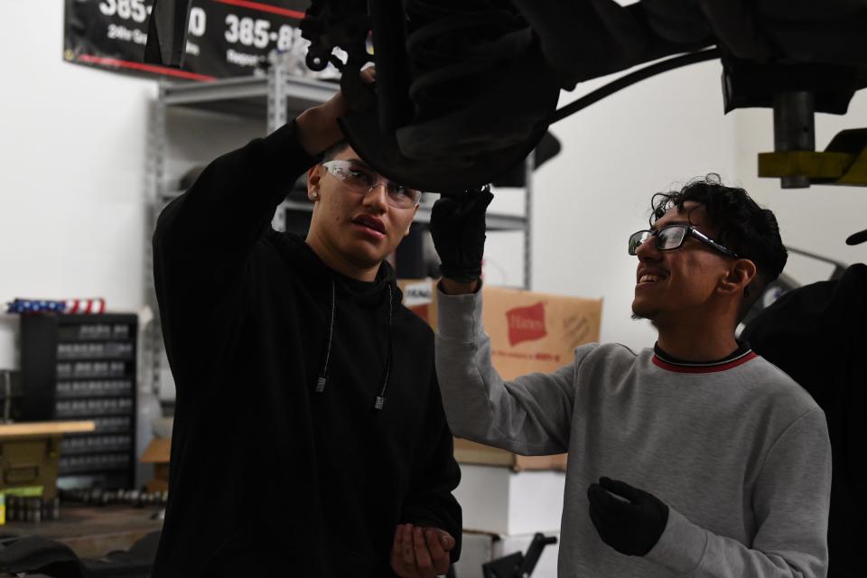 Daniel Naranjo, left, and Jonathan Silva work on a brake assembly at the DRAGG after-school youth automotive program in Oxnard on Wednesday.
