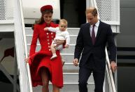 Britain's Prince William, his wife Catherine, Duchess of Cambridge, and their son Prince George disembark from their plane after arriving in Wellington April 7, 2014. The Prince and his wife Kate are undertaking a 19-day official visit to New Zealand and Australia with their son George. REUTERS/Phil Noble (NEW ZEALAND - Tags: ROYALS ENTERTAINMENT)