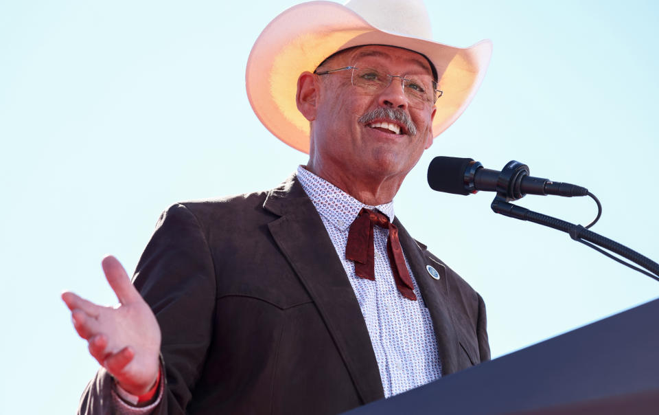 Mark Finchem, Republican nominee for Arizona secretary of state, wearing a cowboy hat, speaks at a rally.