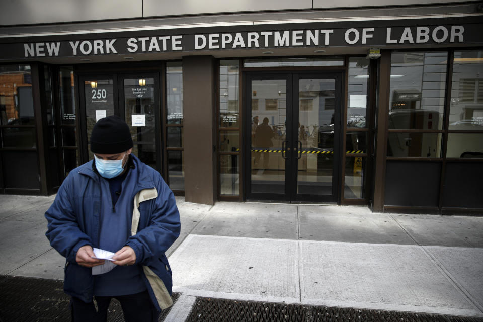 FILE - In this Wednesday, March 18, 2020 file photo, Visitors to the Department of Labor are turned away at the door by personnel due to closures over coronavirus concerns in New York. Americans are seeking unemployment benefits at unprecedented levels due to the coronavirus, but many are finding more frustration than relief. (AP Photo/John Minchillo, File)