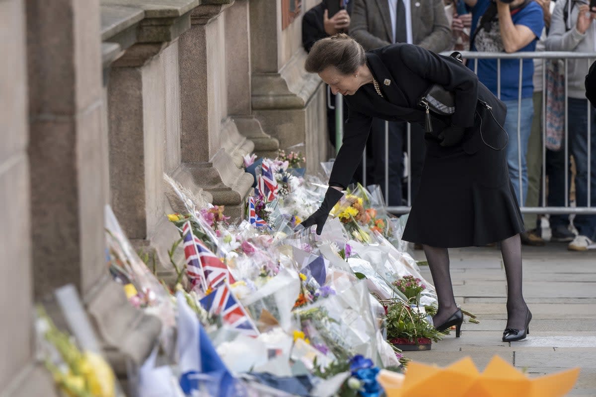 The Princess Royal looks at floral tributes during a visit to Glasgow City Chambers (John Linton/PA) (PA Wire)