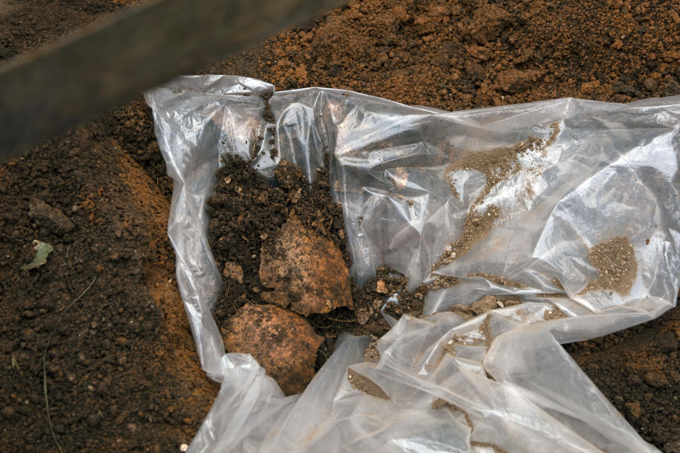 Remains of victims are retrieved from a site, in Huye District, southern Rwanda Tuesday, Jan. 23, 2024. A Rwandan official says the remains of 119 people believed to be victims of genocide have been discovered in the country’s south, as authorities continue to find mass graves nearly three decades after the killings. In April, Rwanda will commemorate the 30th anniversary of the genocide, in which an estimated 800,000 Tutsi and moderate Hutu were killed by Hutu extremists. (AP Photo)