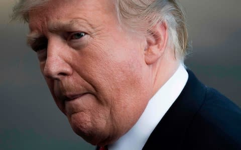 Donald Trump, the US president, made his comments about the 'worst ever cover-up' while speaking to reporters in the White House - Credit:  Jim WATSON / AFP