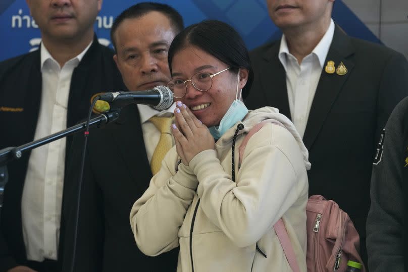 Nutthawaree Munkan talks to reporters after arriving at Suvarnabhumi International Airport in Samut Prakarn Province, Thailand on Thursday