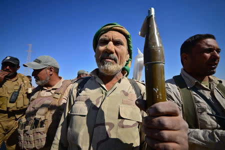 A member of Shi'ite Popular Mobilization Forces (PMF) holds an RPG in Al-Al-Fateha military airport south of Hawija, Iraq, October 2, 2017. REUTERS/Stringer